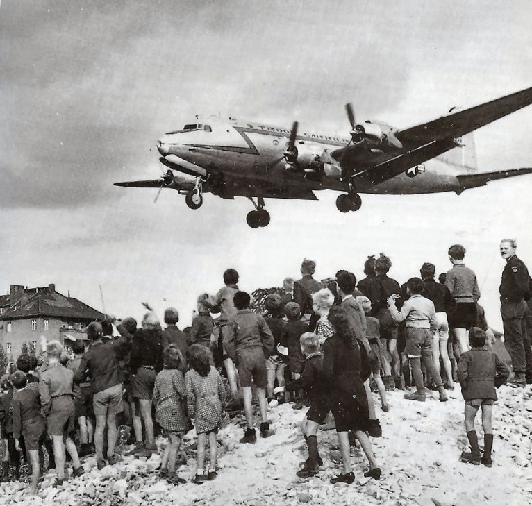 Berliners watch a C-54 transport aircraft land at Tempelhof during the 1948 Berlin Airlift